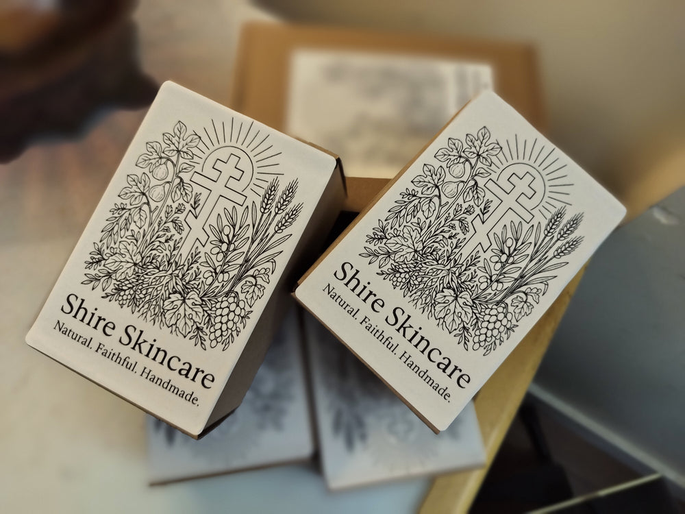 Shire Skincare product packaging with three bar cross design on a blurred background