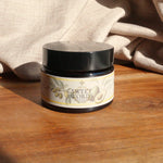Jar of 'Sweet Words' lip scrub on a wooden surface with beige fabric in the background